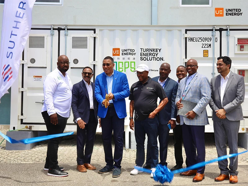 Jamaican Prime Minister poses for a photo in front of UE containerized energy storage cabinet.